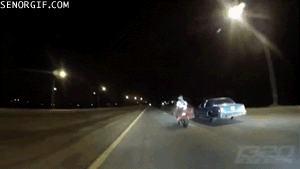 biker gets bumped by car and stays up