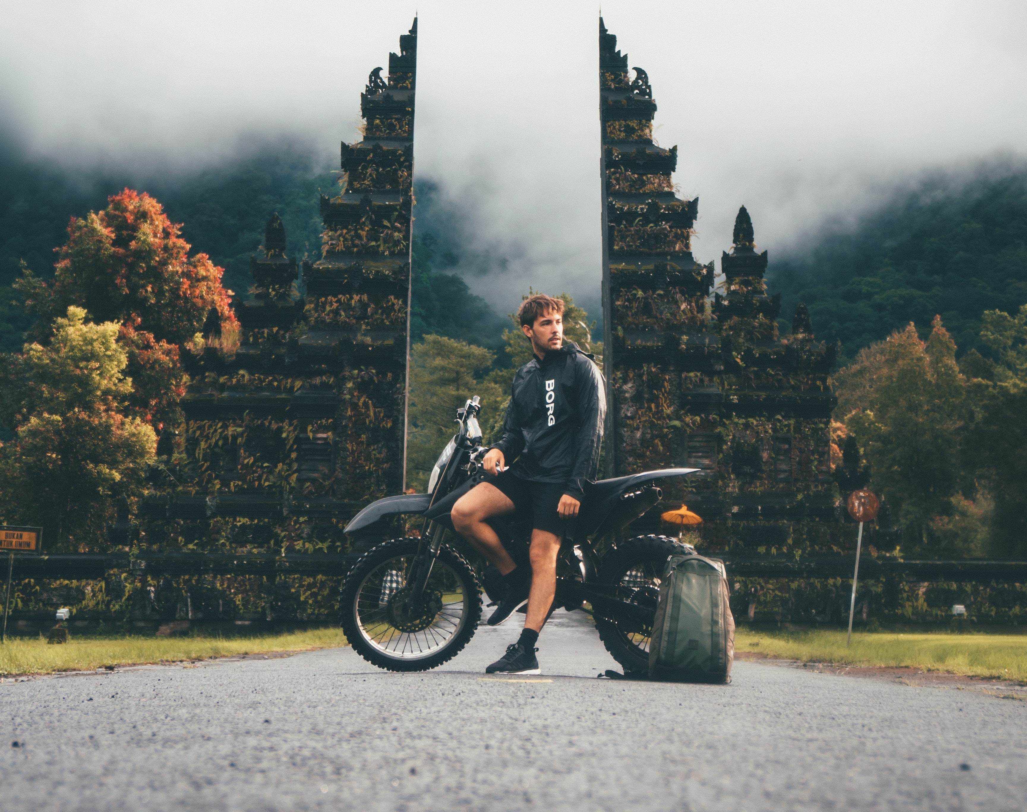Man with a motorcycle and a backpack