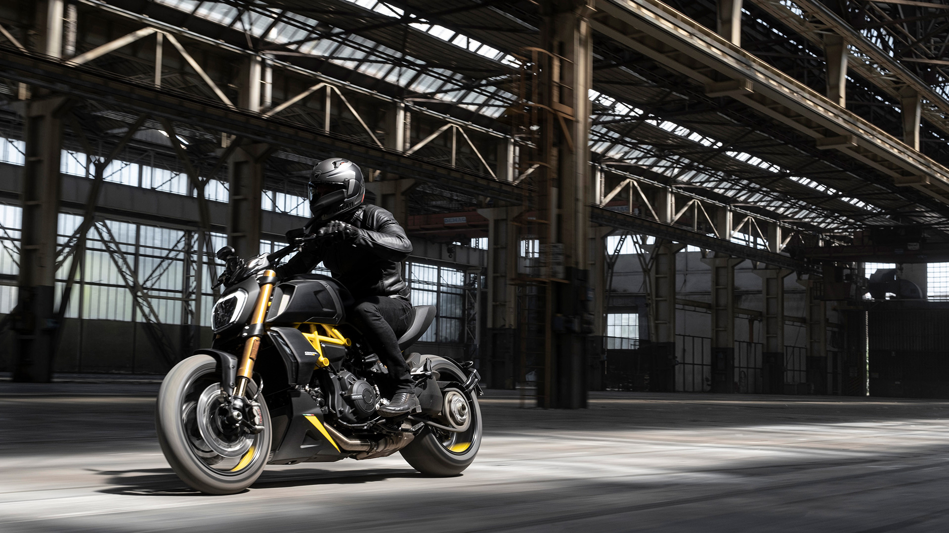 Rider on a 2022 Ducati Diavel 1260 S inside a warehouse