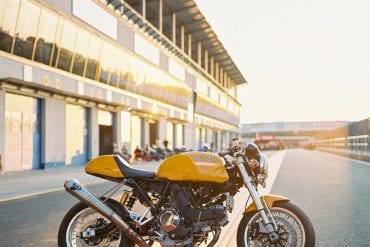 Ducati Sport Classic motorcycle at a race track at sunset