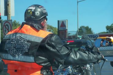 Rider on motorcycle wearing Harley vest