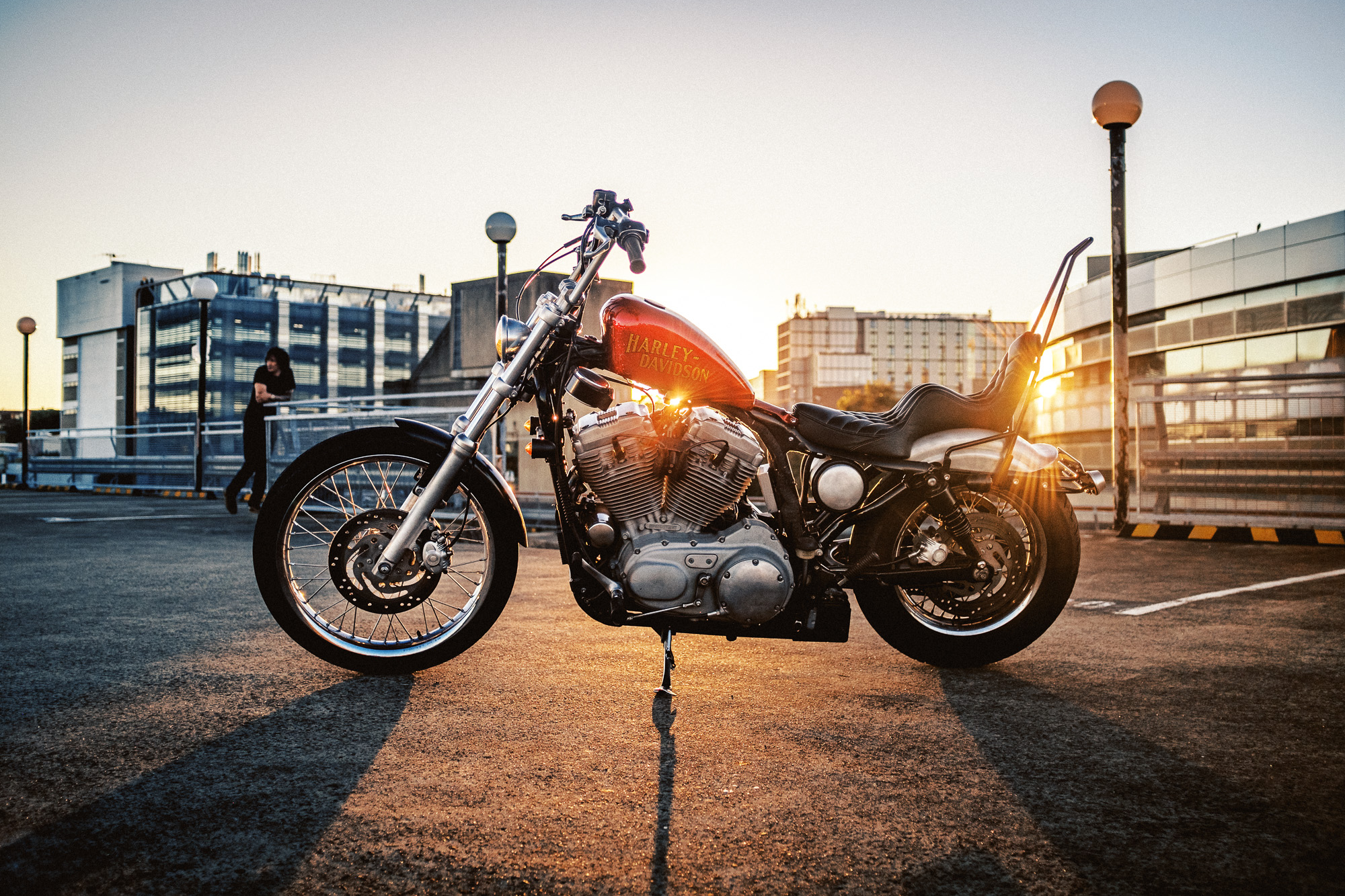 Side of custom Harley-Davidson XLH chopper on Sydney rooftop at sunset