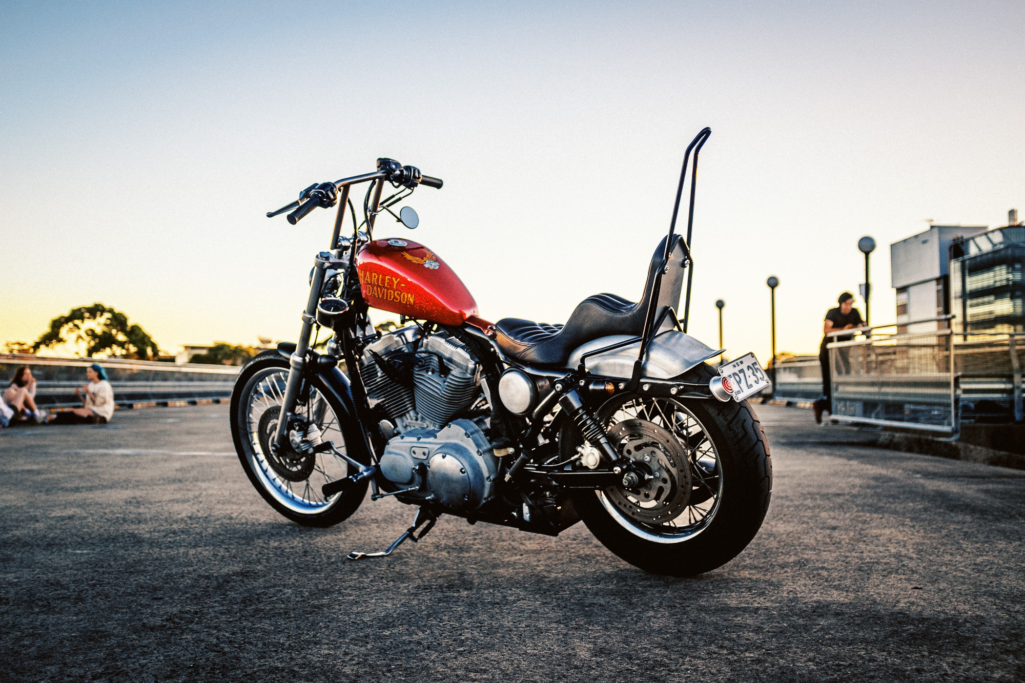 Custom Harley-Davidson XLH chopper on Sydney rooftop at sunset
