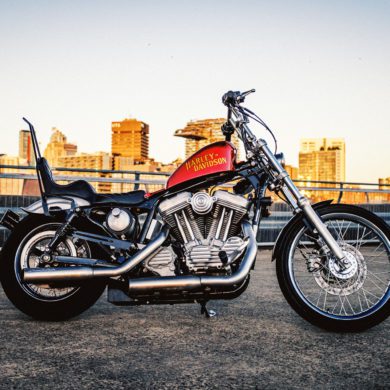 Custom Harley-Davidson XLH chopper on Sydney rooftop at sunset
